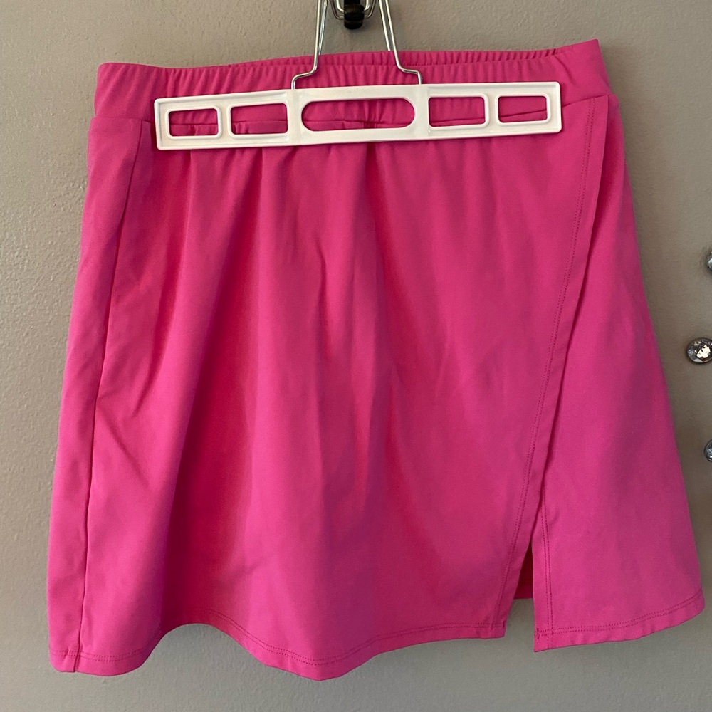Vibrant Pink Skort with Side Slit and side pockets on under shorts. Medium